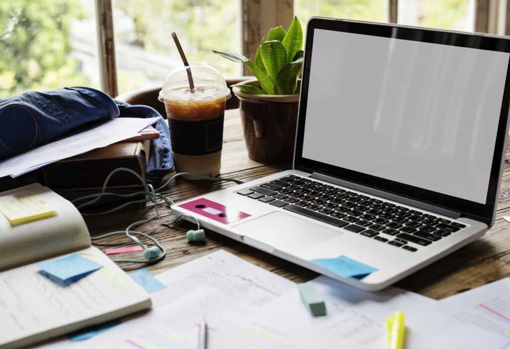 Student workspace with laptop and study materials, showing a flexible setup for those asking, "Is distance learning right for me?"
