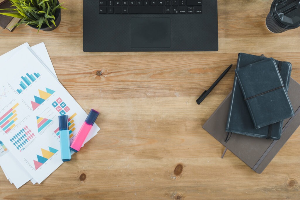 Marketing workspace with charts, notebooks, and laptop—perfect for exploring why a marketing career is the right choice.