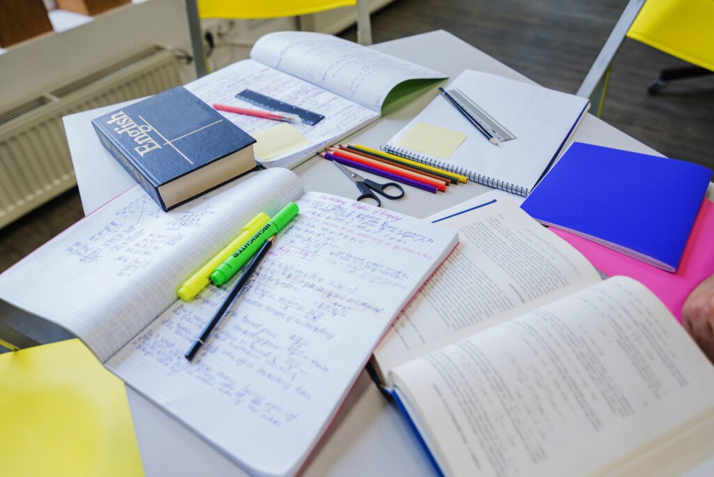 Study table with English books, notepads, and highlighters used for exam prep—helping answer, "Is ABET Level 4 a Matric Certificate?