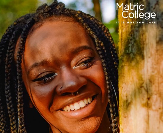African woman smiling confidently after completing a make-up applications short course